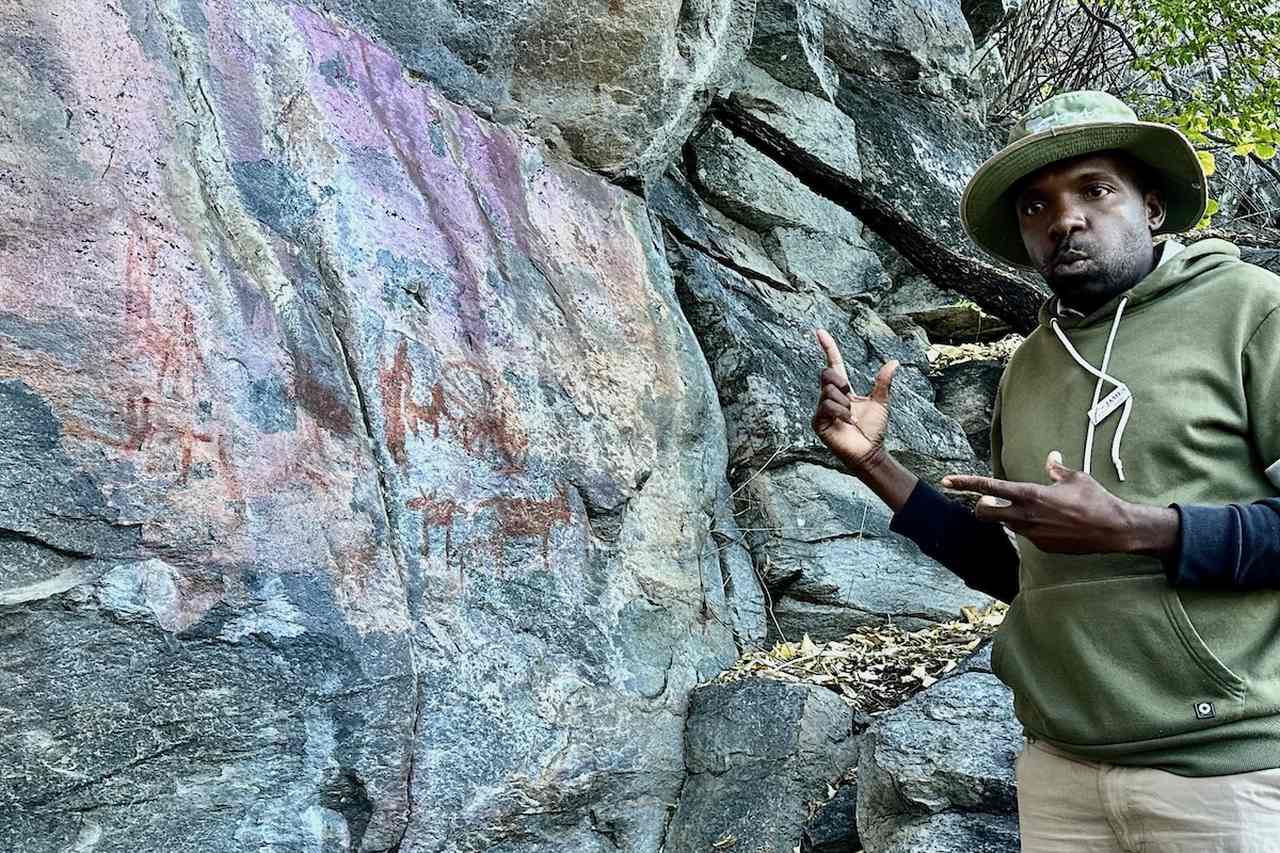 Adam, the Local Guide, Discussing a Rock Painting on the Tsodilo Hills Excursion from the Okavango Delta in Botswana