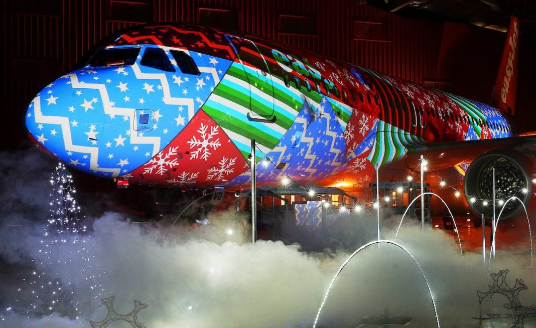 Luton airport sees an easyjet A320 Airbus wrapped in Christmas lights